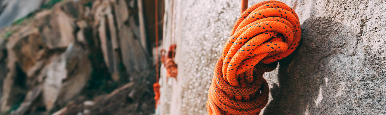 Climbing ropes handing on the mountain cliff